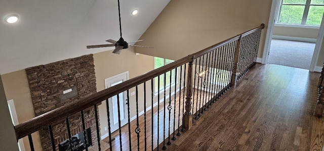 hallway featuring hardwood / wood-style flooring and lofted ceiling