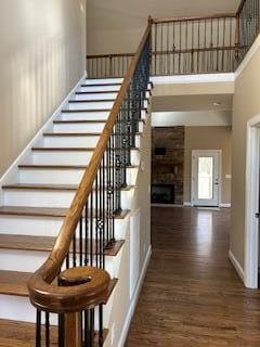 stairway featuring hardwood / wood-style floors and a high ceiling