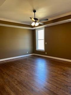 unfurnished room with crown molding, ceiling fan, and dark hardwood / wood-style floors