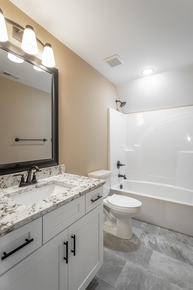 bathroom with toilet, bathtub / shower combination, visible vents, and vanity