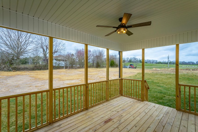 unfurnished sunroom with ceiling fan