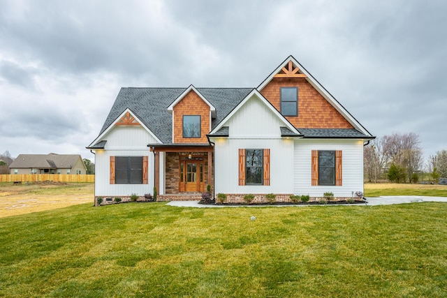 modern farmhouse style home featuring a shingled roof and a front lawn