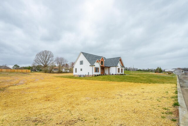 view of side of property featuring a yard