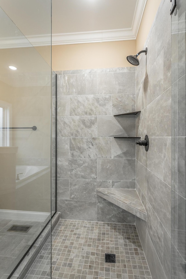 full bath featuring ornamental molding and tiled shower