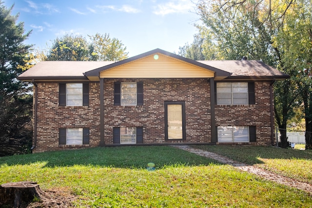 raised ranch featuring a front lawn