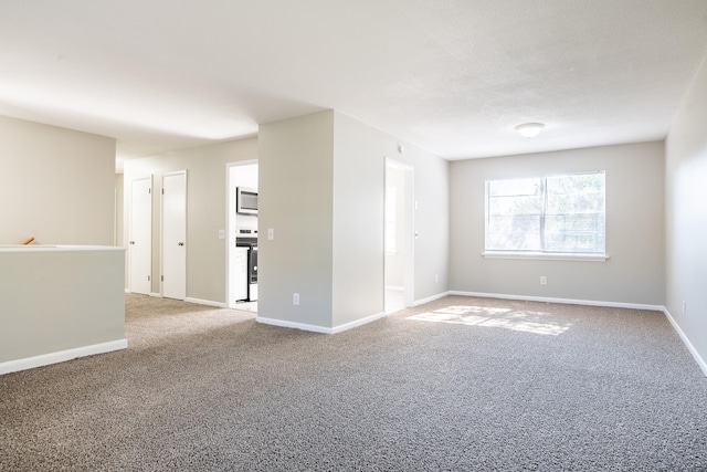 unfurnished room featuring carpet flooring