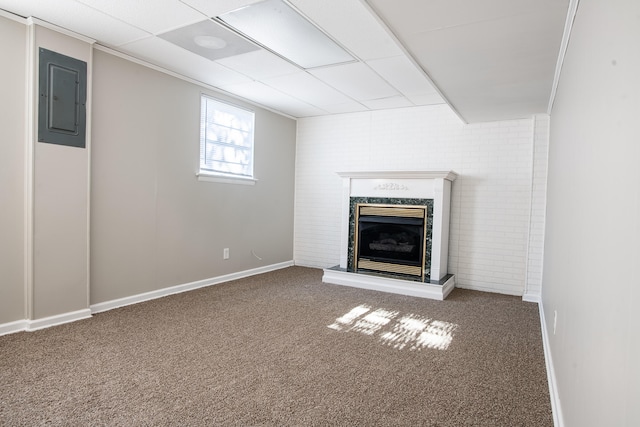 basement featuring ornamental molding, electric panel, and dark carpet