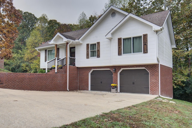 view of front of house featuring an attached garage, driveway, brick siding, and a shingled roof
