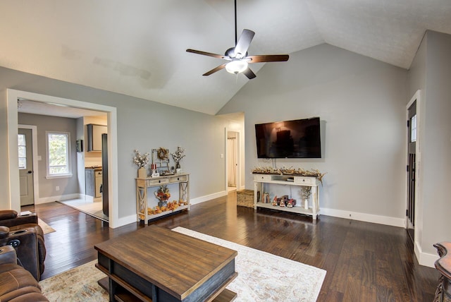 living room featuring ceiling fan, lofted ceiling, wood finished floors, and baseboards