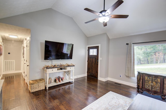 living area with attic access, ceiling fan, plenty of natural light, wood finished floors, and high vaulted ceiling
