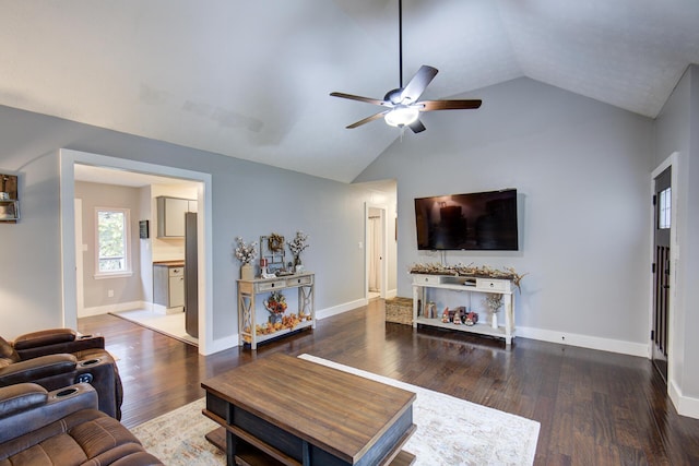 living area featuring a ceiling fan, lofted ceiling, wood finished floors, and baseboards