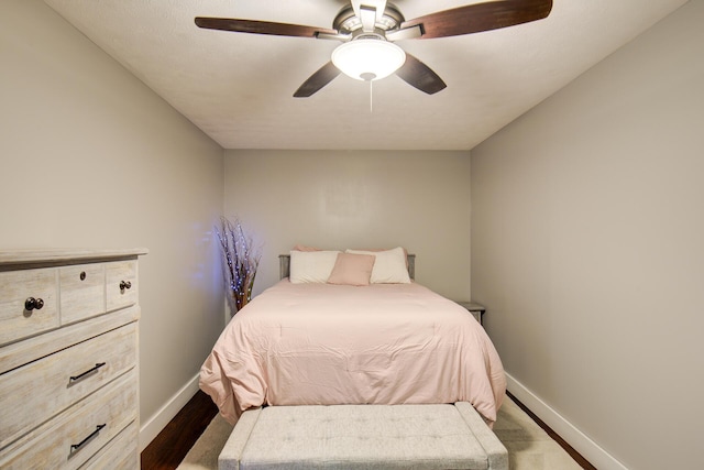bedroom featuring baseboards and ceiling fan