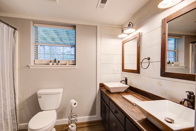 bathroom featuring vanity, toilet, a healthy amount of sunlight, and hardwood / wood-style flooring