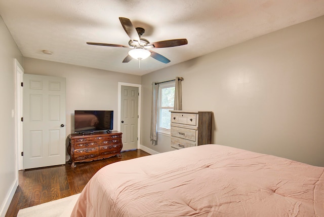 bedroom with ceiling fan and dark hardwood / wood-style floors