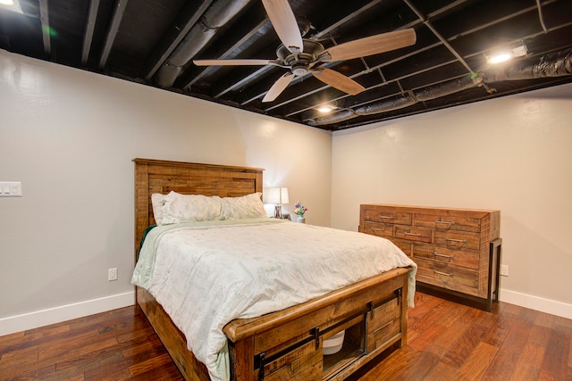 bedroom with dark hardwood / wood-style floors and ceiling fan