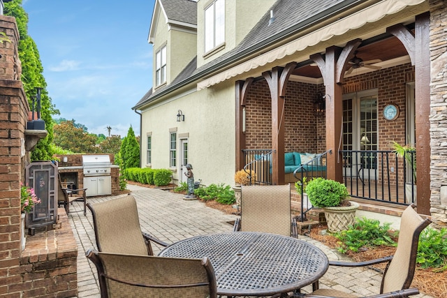 view of patio / terrace featuring ceiling fan, a grill, and area for grilling