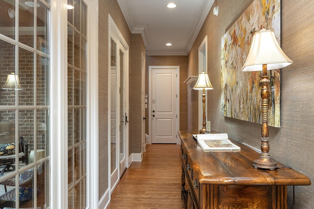 hall featuring ornamental molding and hardwood / wood-style floors