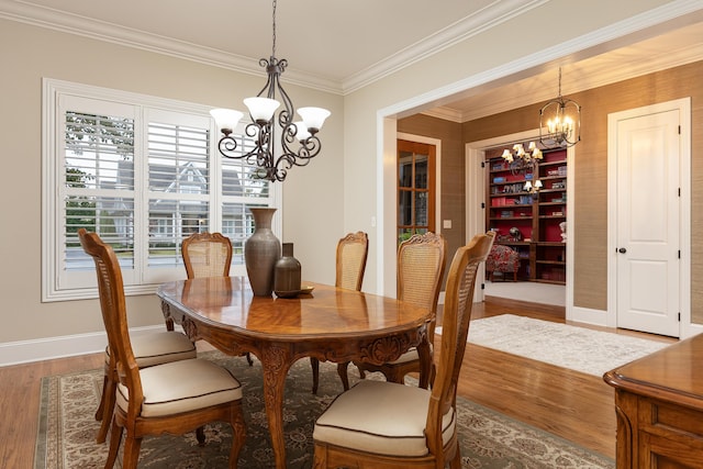 dining room featuring crown molding, hardwood / wood-style flooring, and a notable chandelier