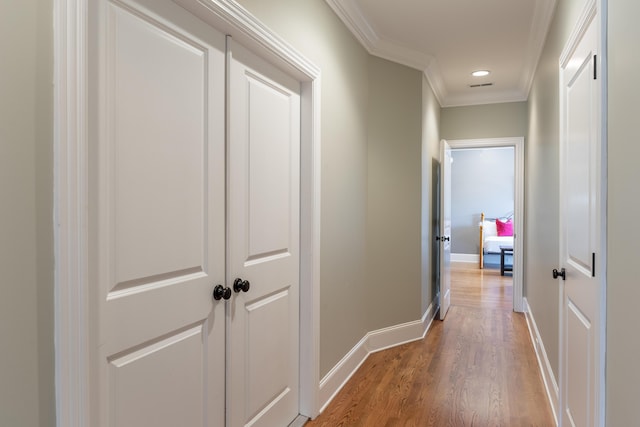 hall with crown molding and hardwood / wood-style flooring