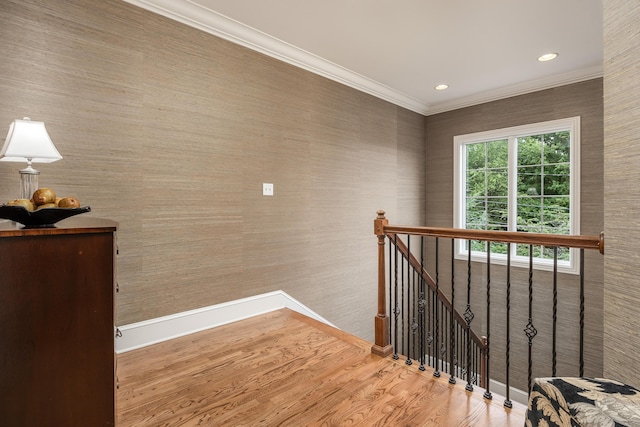 stairs featuring wood-type flooring and crown molding