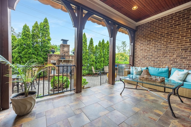 view of patio / terrace with an outdoor living space with a fireplace