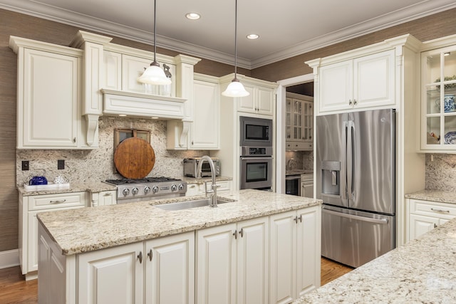 kitchen with decorative light fixtures, decorative backsplash, appliances with stainless steel finishes, and sink