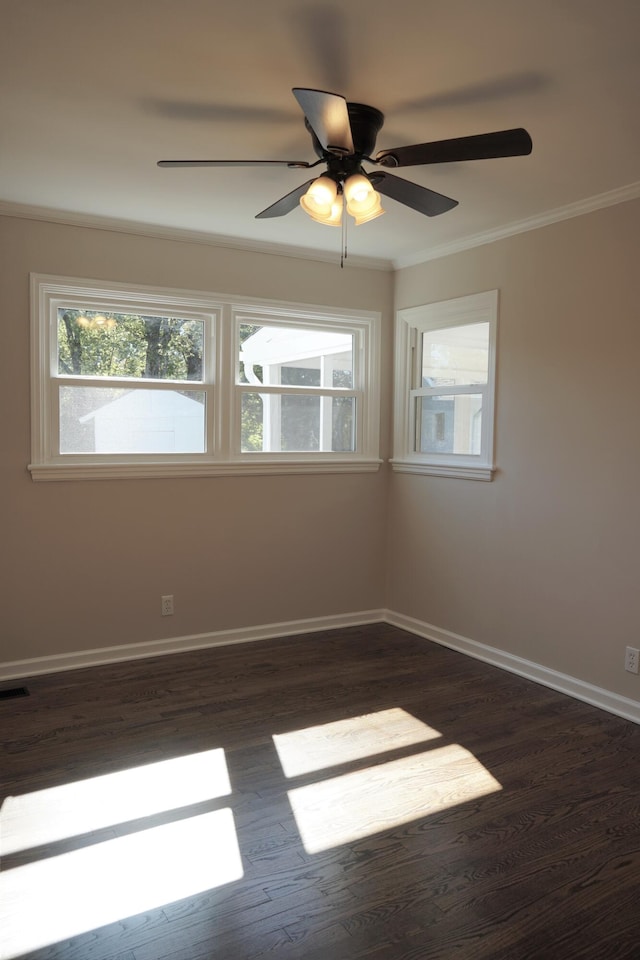 empty room with ornamental molding, ceiling fan, and dark hardwood / wood-style flooring