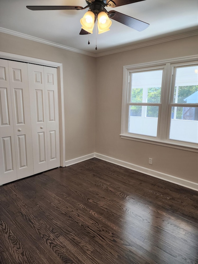 unfurnished bedroom featuring ceiling fan, crown molding, and dark hardwood / wood-style floors