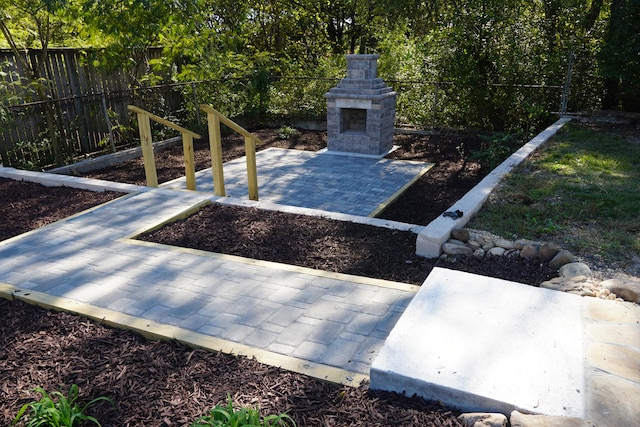 view of yard featuring an outdoor stone fireplace