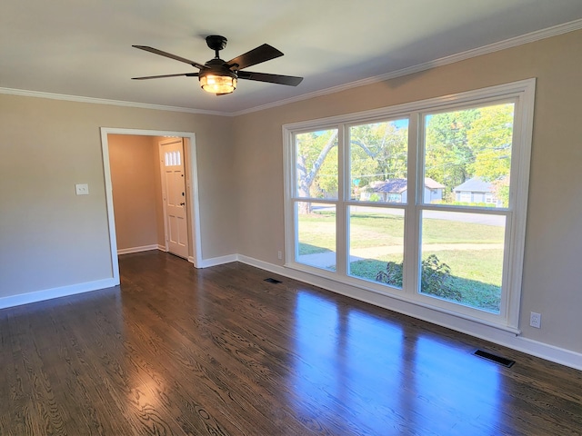 empty room with ornamental molding, dark wood-type flooring, and ceiling fan