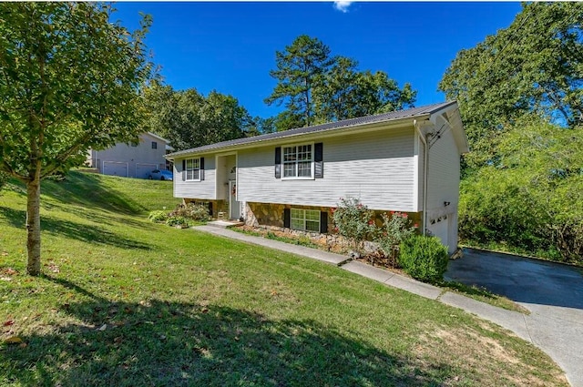 raised ranch with a front yard