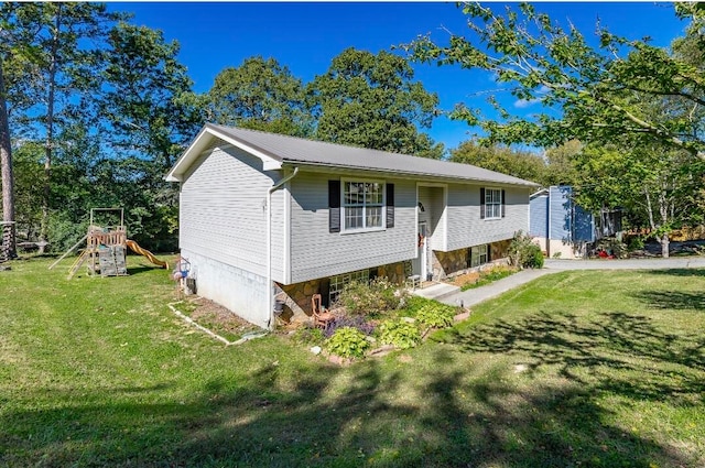 bi-level home featuring a front yard and a playground