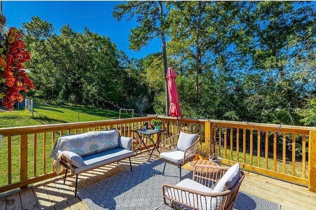 wooden terrace featuring an outdoor hangout area and a yard