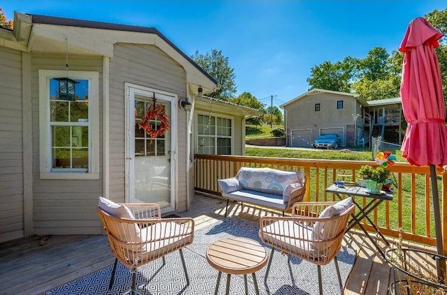 deck featuring an outdoor living space and a lawn