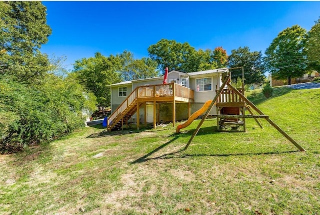 view of jungle gym featuring a wooden deck and a yard