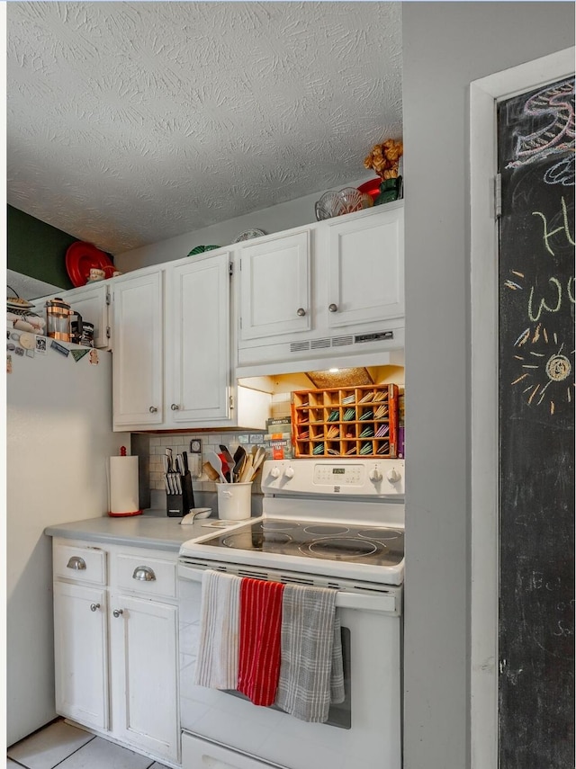 kitchen with white cabinetry, a textured ceiling, range hood, and white range with electric cooktop