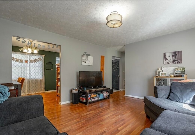 living room featuring hardwood / wood-style flooring and a textured ceiling