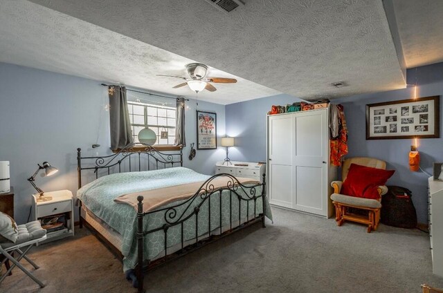 bedroom featuring carpet, a textured ceiling, and ceiling fan