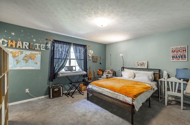 bedroom with a textured ceiling and carpet floors