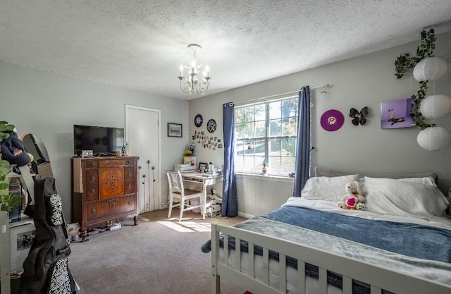 bedroom with a textured ceiling, carpet floors, and an inviting chandelier