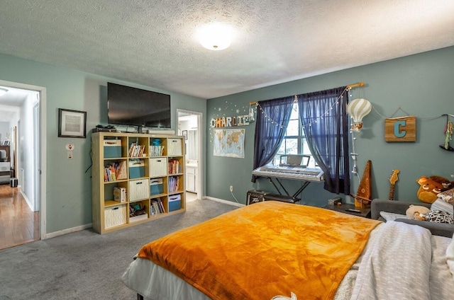 bedroom with a textured ceiling and carpet floors