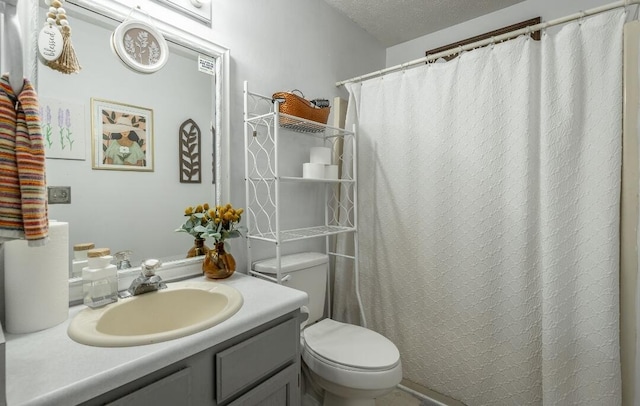 bathroom featuring vanity, a textured ceiling, toilet, and a shower with shower curtain