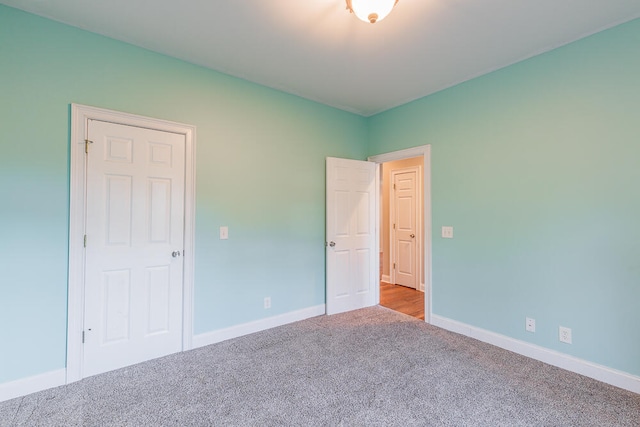 unfurnished bedroom featuring light carpet