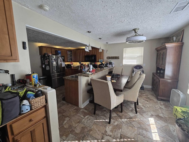 dining space with a textured ceiling