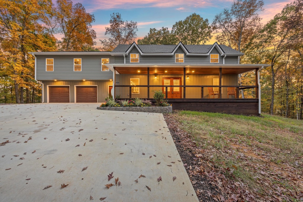 view of front of home featuring covered porch and a garage