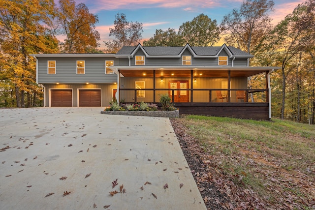 view of front of home featuring covered porch and a garage