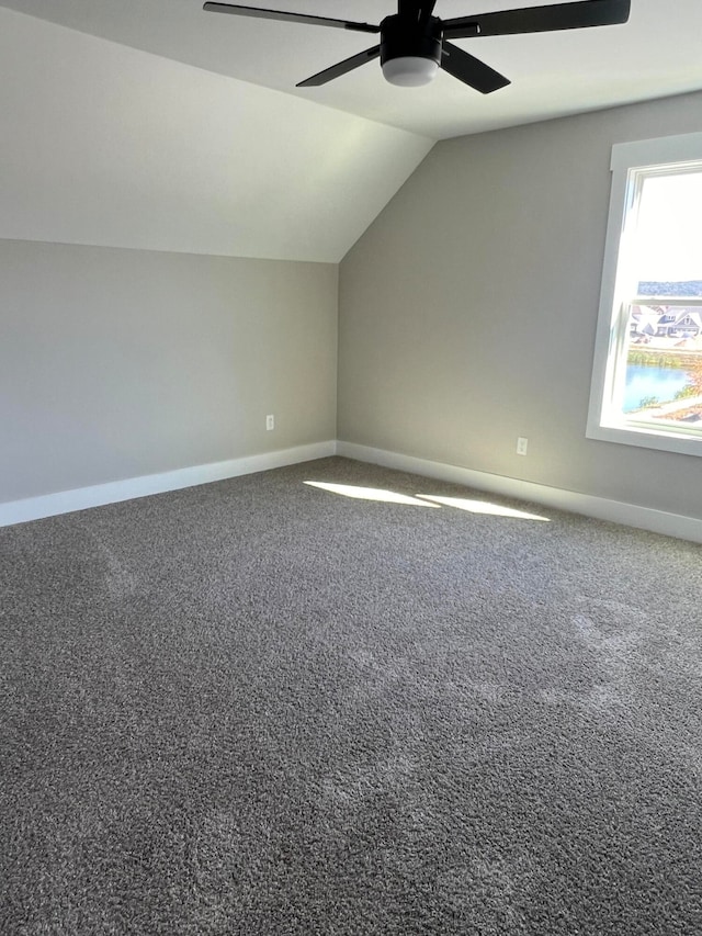 additional living space featuring vaulted ceiling, carpet floors, and ceiling fan