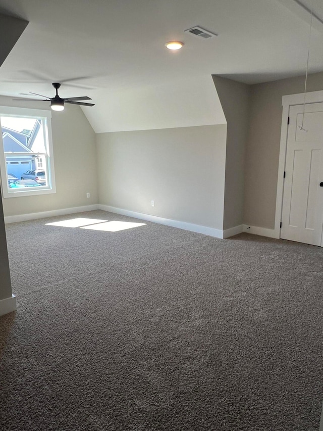 additional living space with vaulted ceiling, carpet floors, and ceiling fan