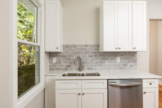 kitchen with sink, a healthy amount of sunlight, dishwasher, and white cabinets