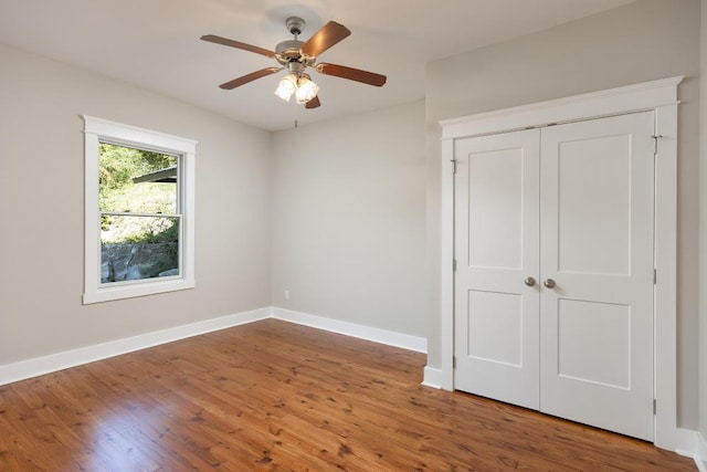 unfurnished bedroom featuring a closet, ceiling fan, and hardwood / wood-style flooring